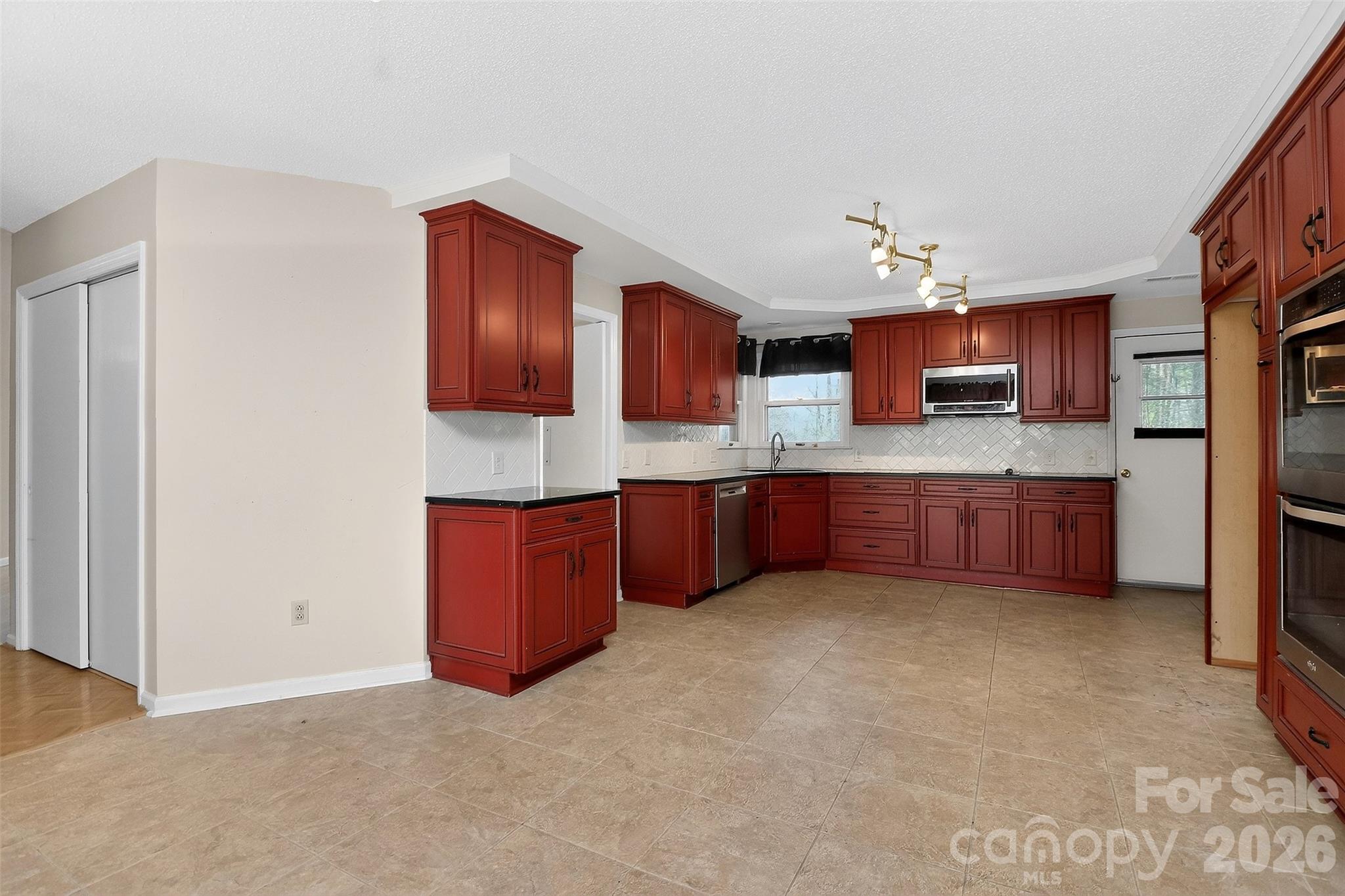 9516 Westmoreland Road Cornelius, NC 28031 - Photo 11 of 40 a kitchen with stainless steel appliances granite countertop a refrigerator and a stove top oven