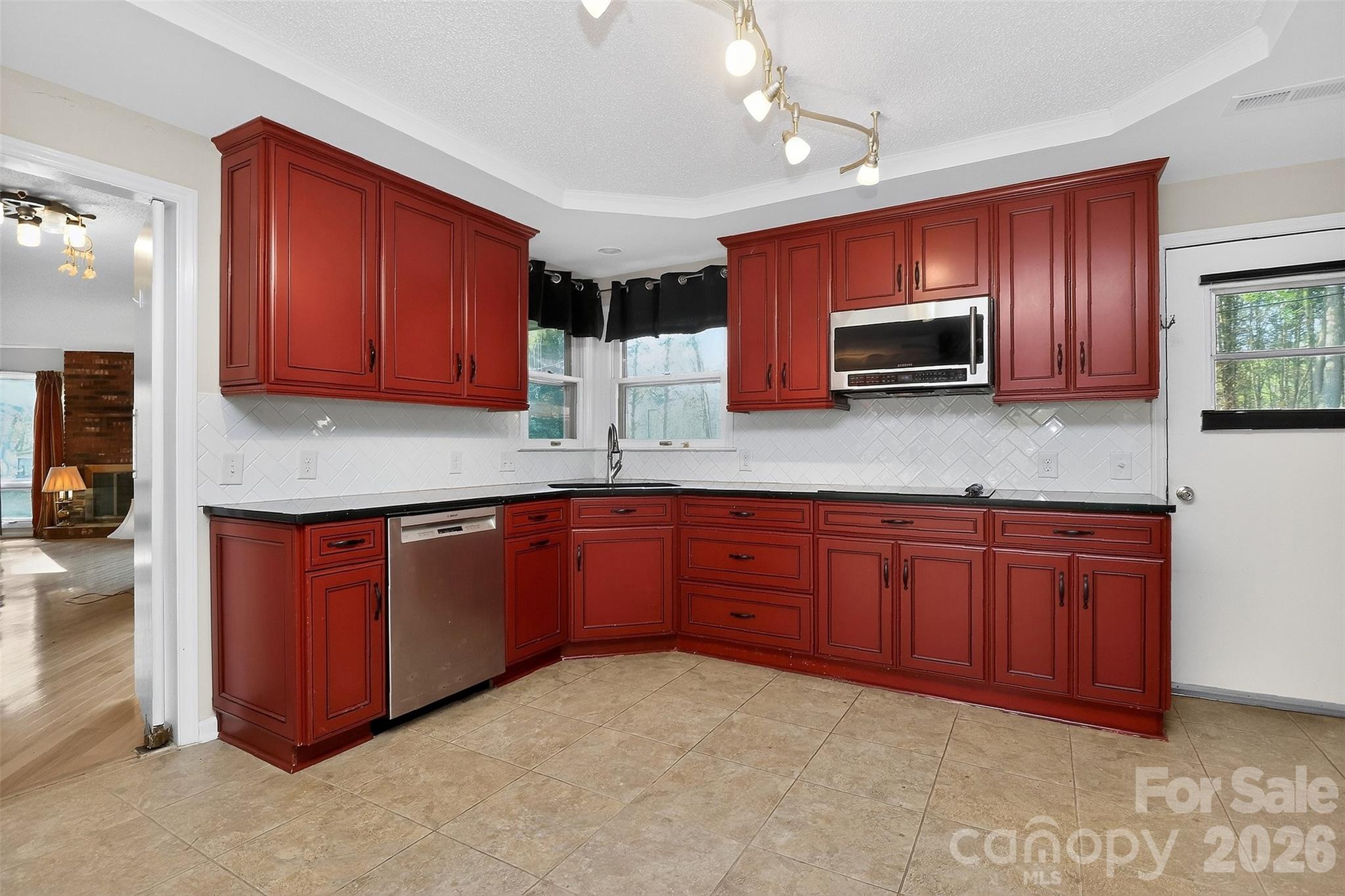 9516 Westmoreland Road Cornelius, NC 28031 - Photo 12 of 40 a kitchen with stainless steel appliances granite countertop wooden cabinets a stove top oven a sink and dishwasher
