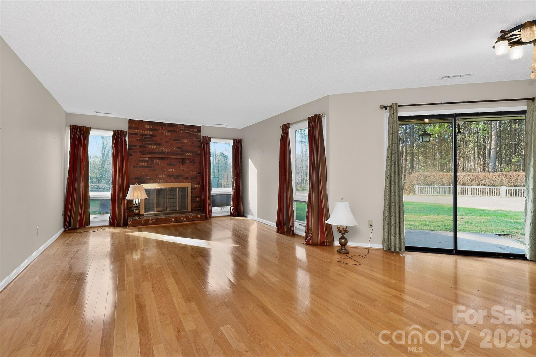 9516 Westmoreland Road Cornelius, NC 28031 - Photo 16 of 40 a view of a room with wooden floor and a fireplace