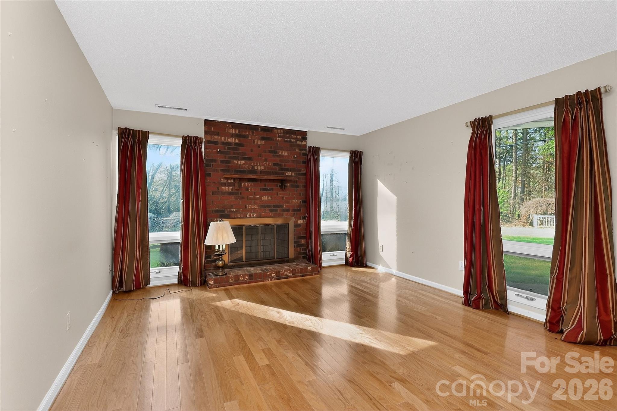 9516 Westmoreland Road Cornelius, NC 28031 - Photo 17 of 40 a view of an empty room with a fireplace and a window