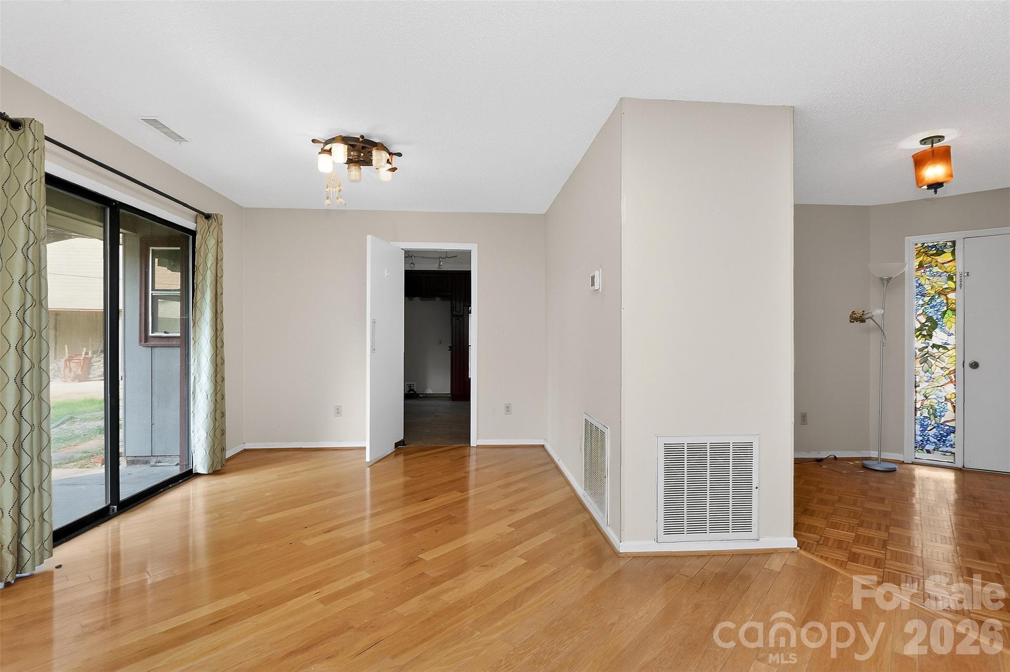 9516 Westmoreland Road Cornelius, NC 28031 - Photo 19 of 40 a view of an empty room with window and wooden floor
