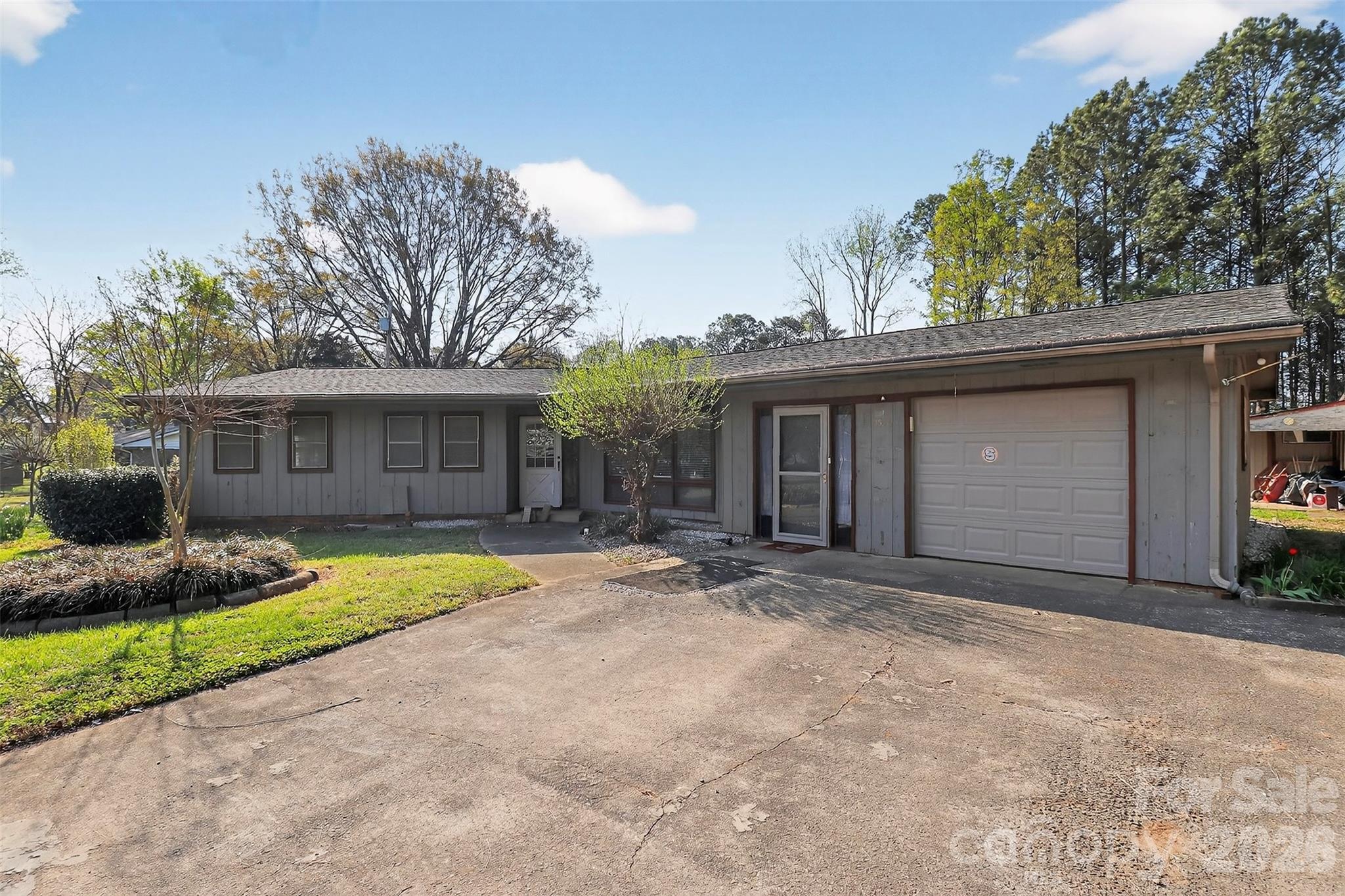 9516 Westmoreland Road Cornelius, NC 28031 - Photo 2 of 40 a front view of a house with a garden and trees