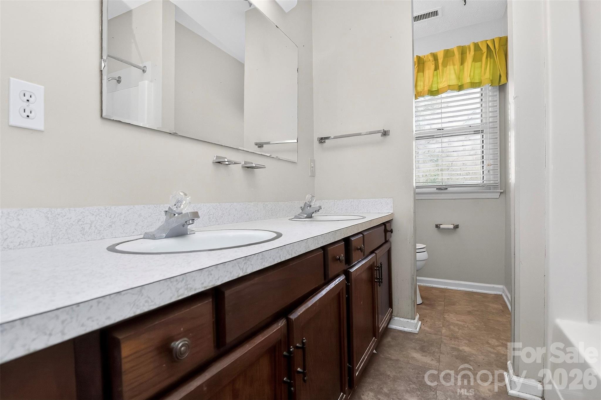 9516 Westmoreland Road Cornelius, NC 28031 - Photo 31 of 40 a bathroom with a sink and a mirror