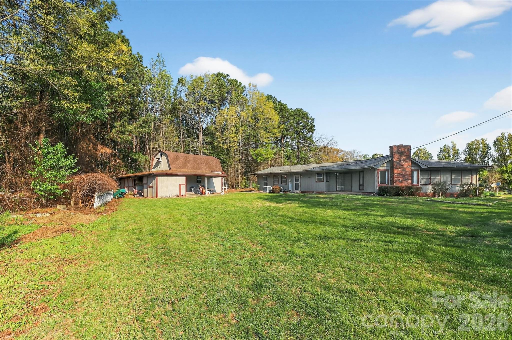 9516 Westmoreland Road Cornelius, NC 28031 - Photo 35 of 40 a view of a big house with a big yard and large trees