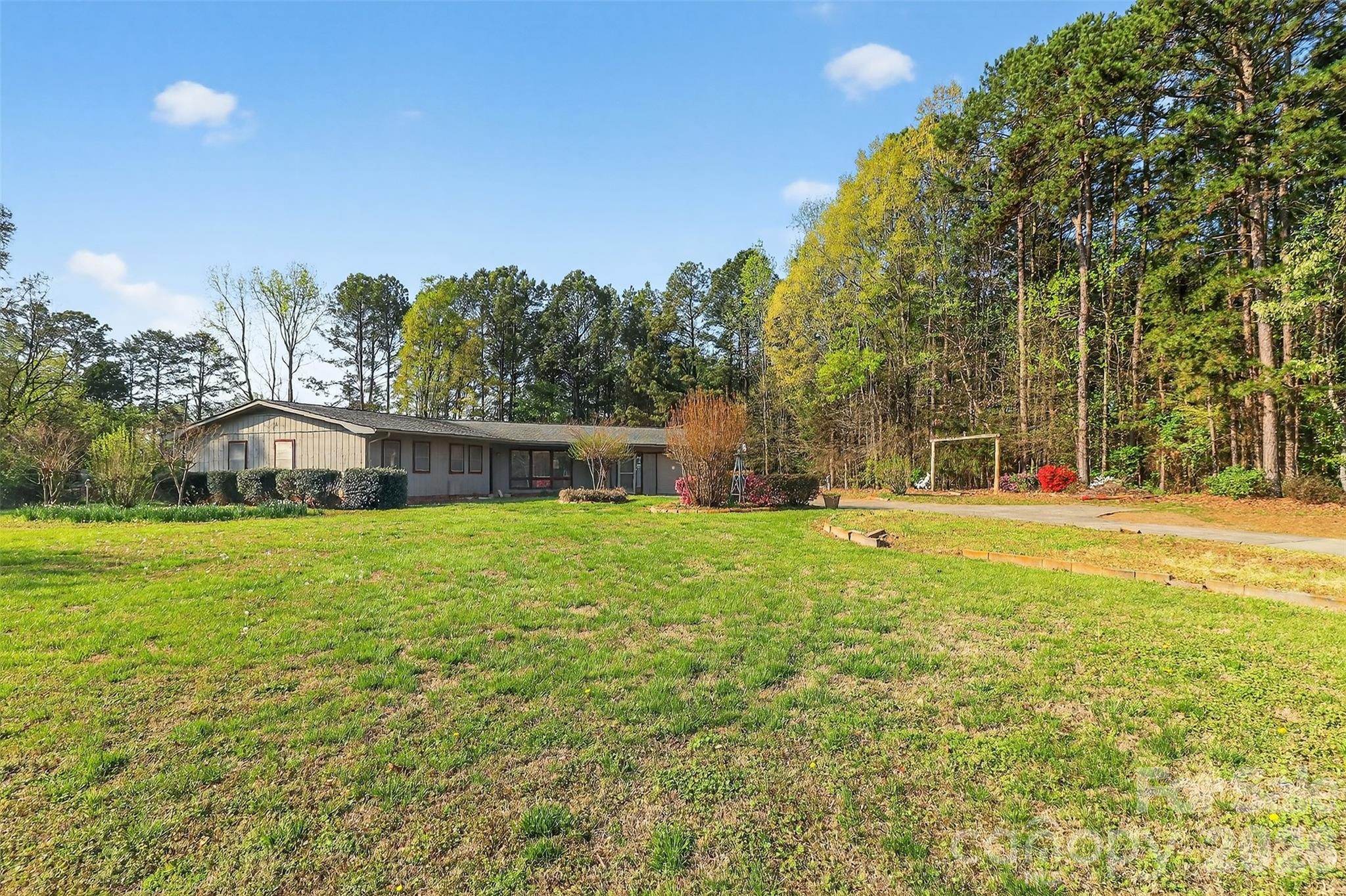 9516 Westmoreland Road Cornelius, NC 28031 - Photo 5 of 40 a swimming pool with outdoor seating and yard