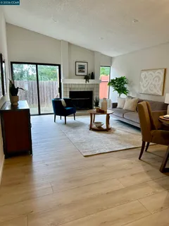 a living room with furniture and a potted plant on table