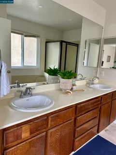 a bathroom with double vanity sinks and a mirror
