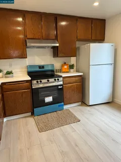 a kitchen with a stove and a refrigerator