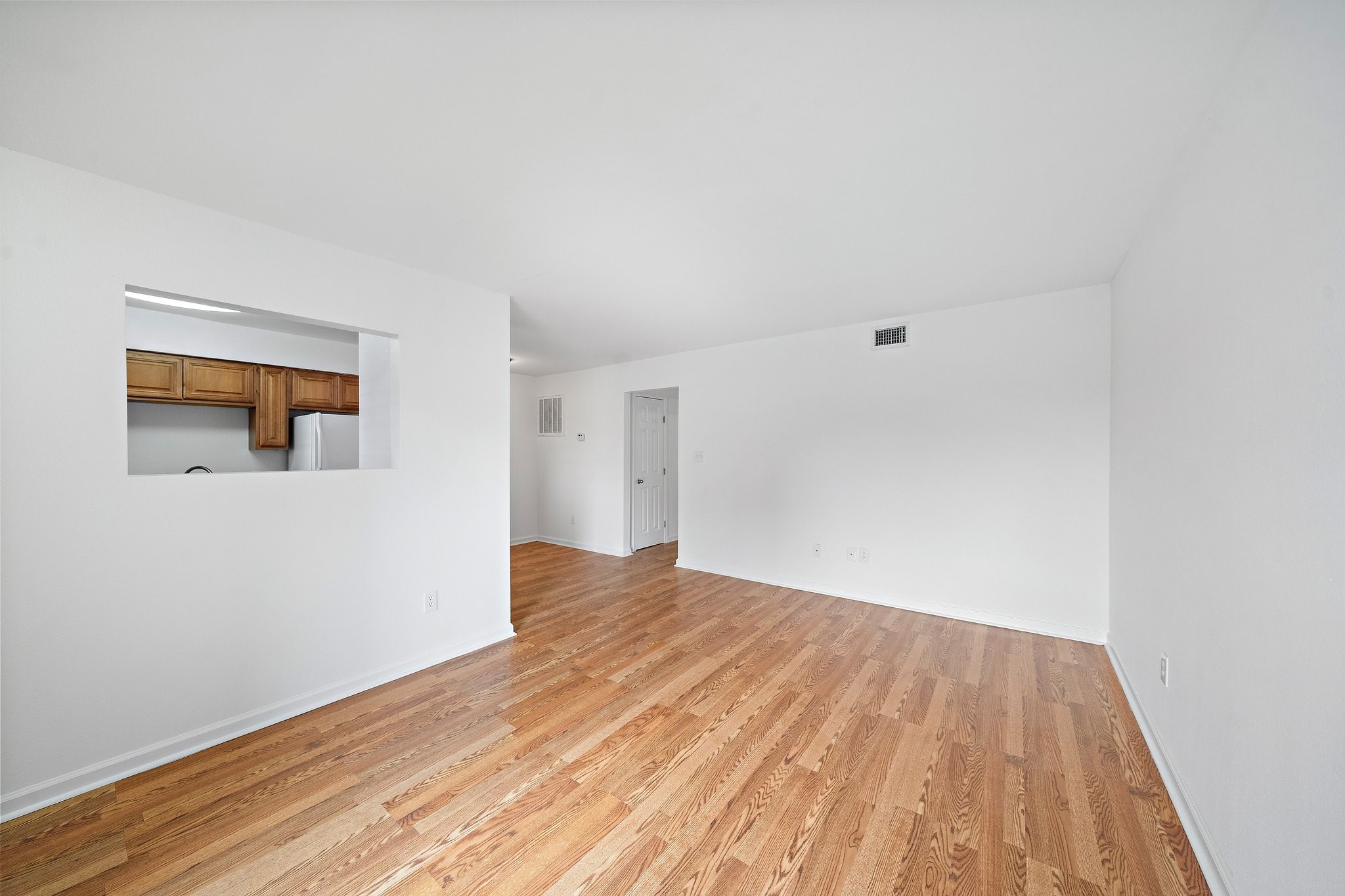 100 Market Street, Unit 55 Galveston, TX 77550 - Photo 3 of 9 a view of an empty room with wooden floor and a window