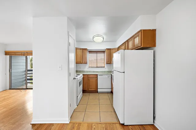 a kitchen with a refrigerator and a more cabinets