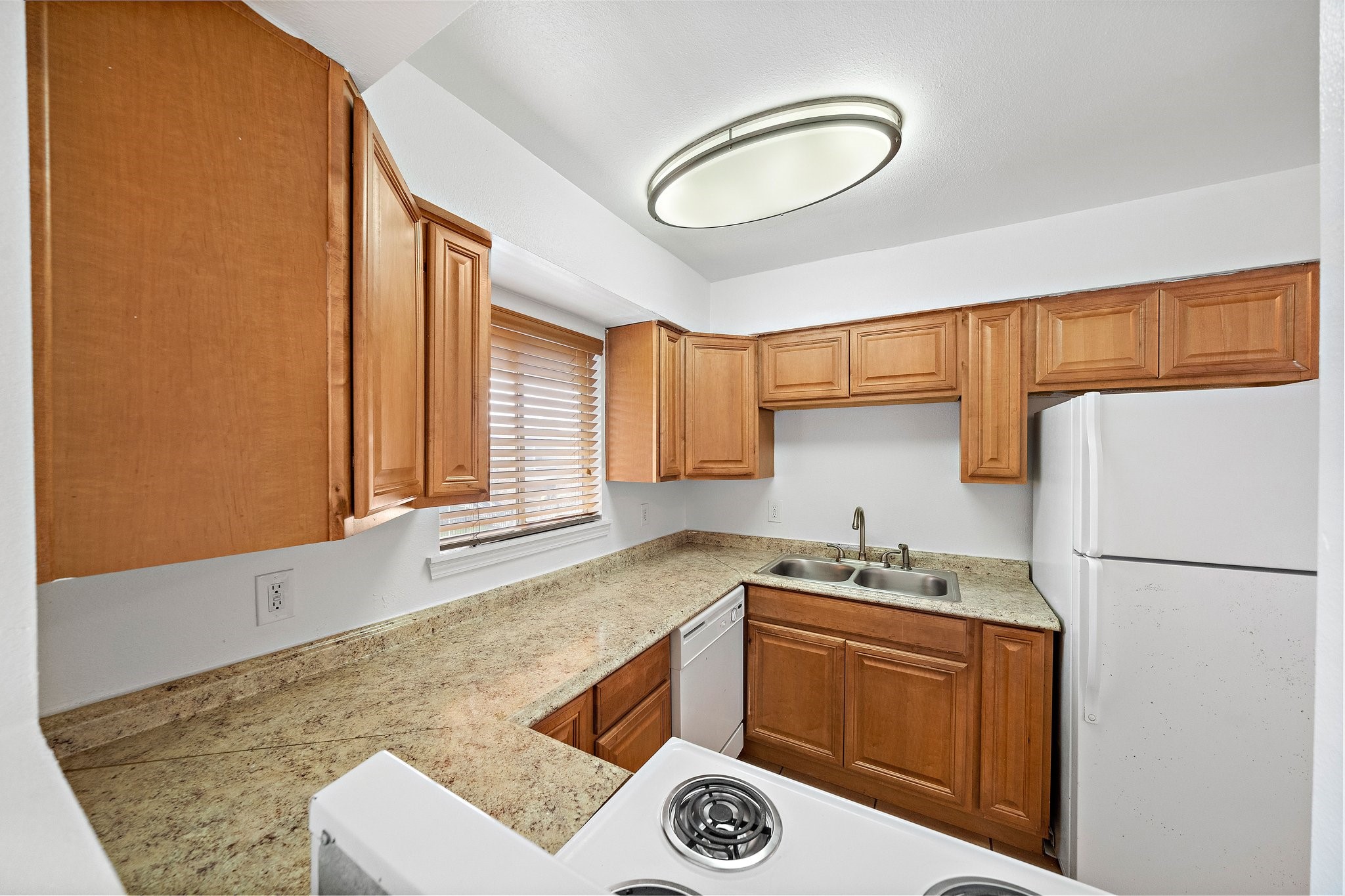 100 Market Street, Unit 55 Galveston, TX 77550 - Photo 5 of 9 a kitchen with a refrigerator and a sink