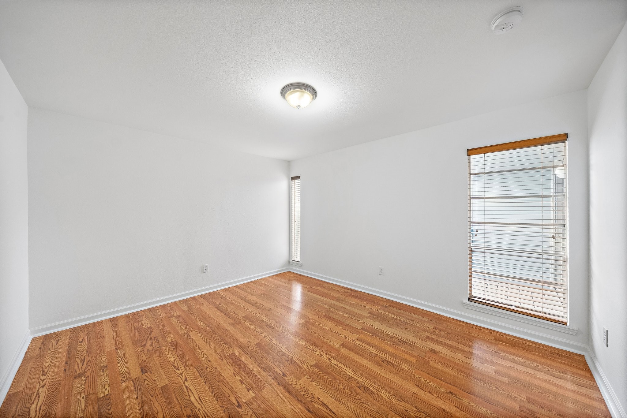 100 Market Street, Unit 55 Galveston, TX 77550 - Photo 8 of 9 a view of an empty room with wooden floor and a window
