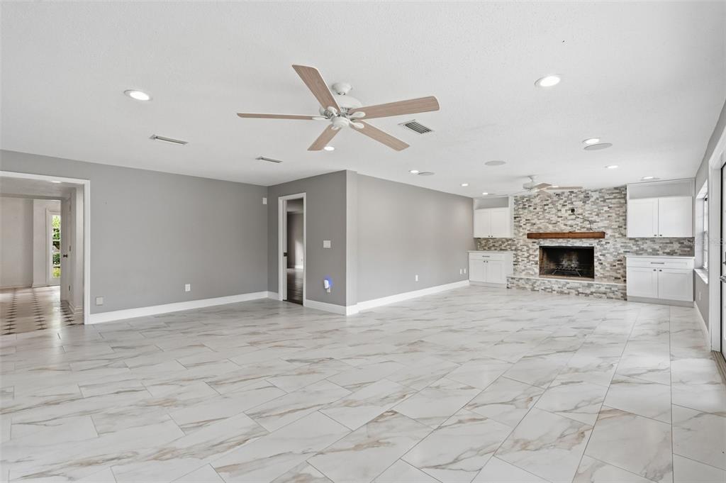 1840 Salem Court Dunedin, FL 34698 - Photo 11 of 64 a view of an empty room with a fireplace
