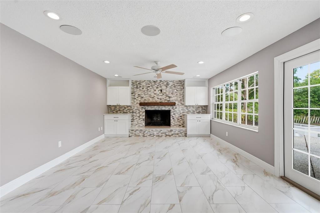 1840 Salem Court Dunedin, FL 34698 - Photo 12 of 64 a view of an empty room with a fireplace and a window