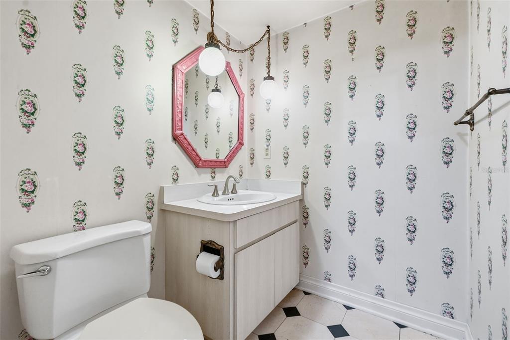 1840 Salem Court Dunedin, FL 34698 - Photo 15 of 64 a bathroom with a sink a mirror and a toilet