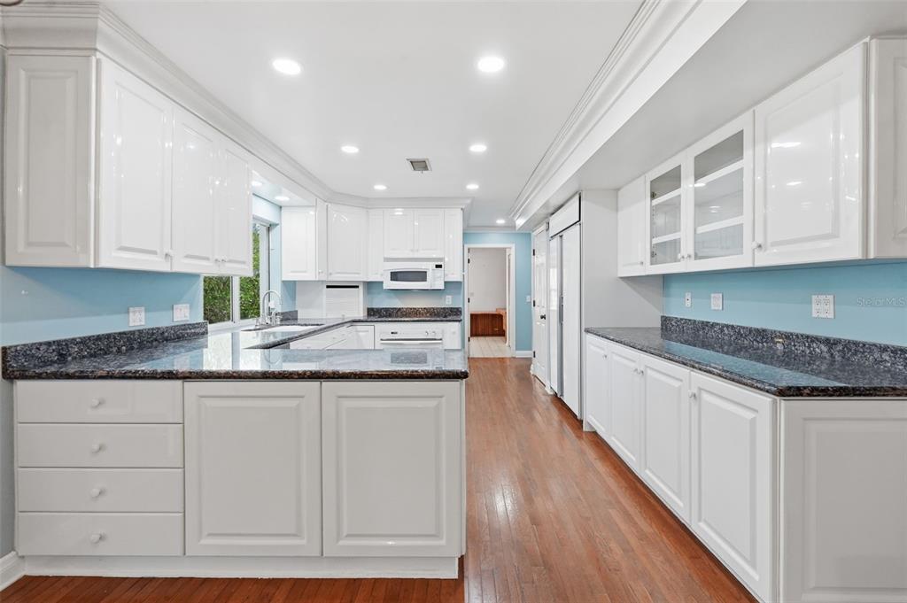 1840 Salem Court Dunedin, FL 34698 - Photo 17 of 64 a kitchen with granite countertop a sink and cabinets