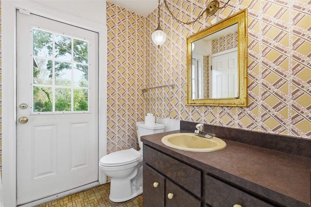 1840 Salem Court Dunedin, FL 34698 - Photo 22 of 64 a bathroom with a granite countertop sink toilet and a mirror