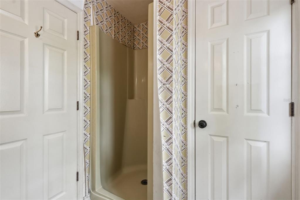 1840 Salem Court Dunedin, FL 34698 - Photo 23 of 64 a bathroom with a shower curtain