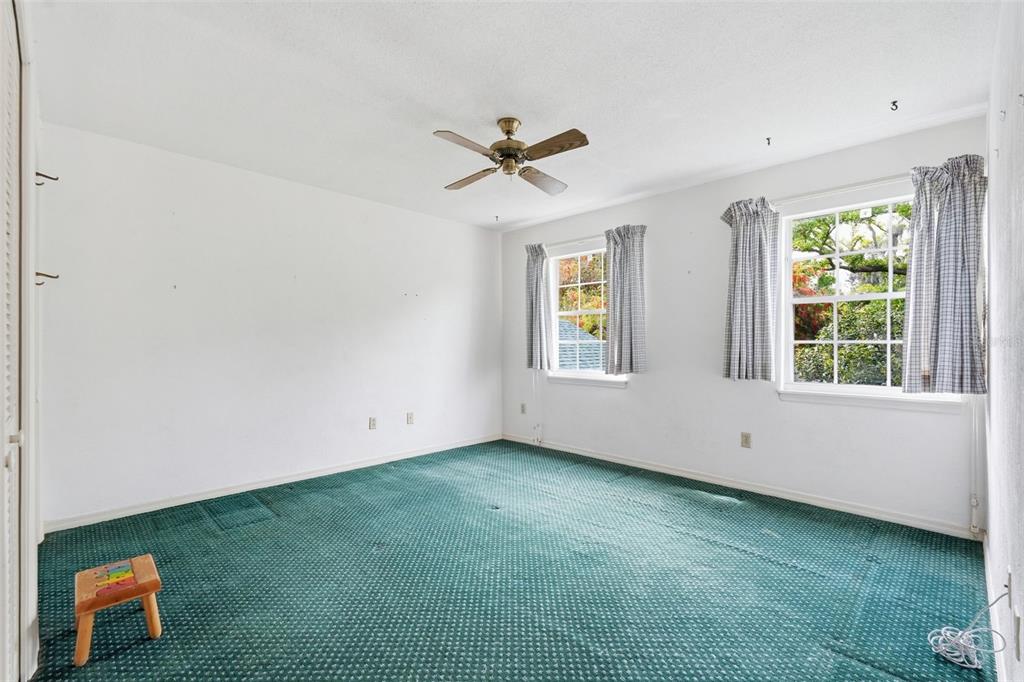 1840 Salem Court Dunedin, FL 34698 - Photo 29 of 64 an empty room with windows and fan