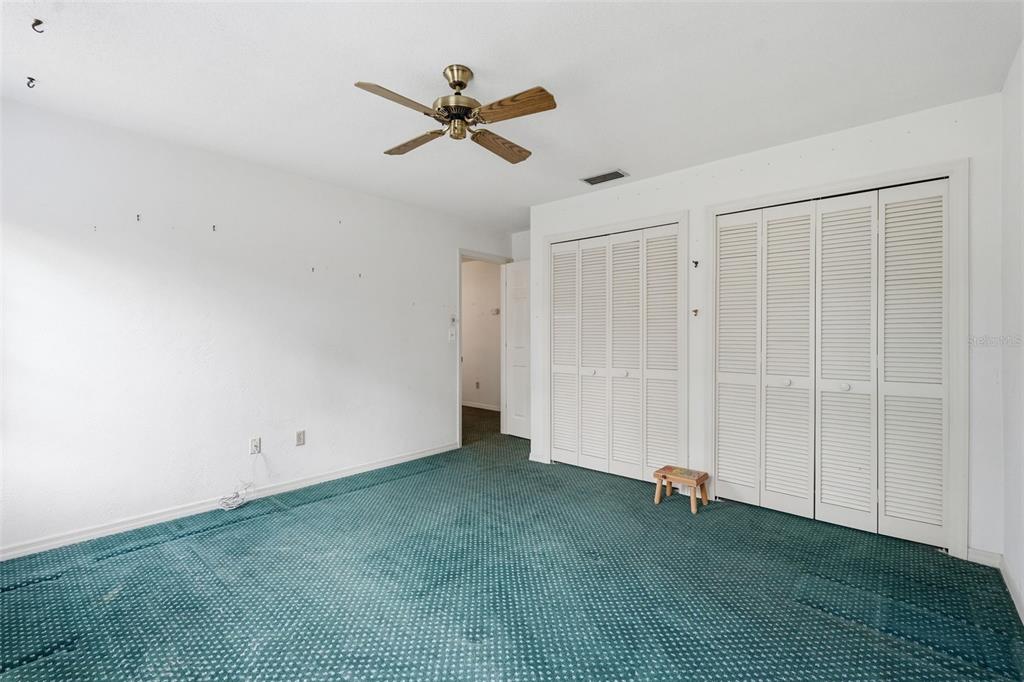 1840 Salem Court Dunedin, FL 34698 - Photo 30 of 64 an empty room with a ceiling fan and window