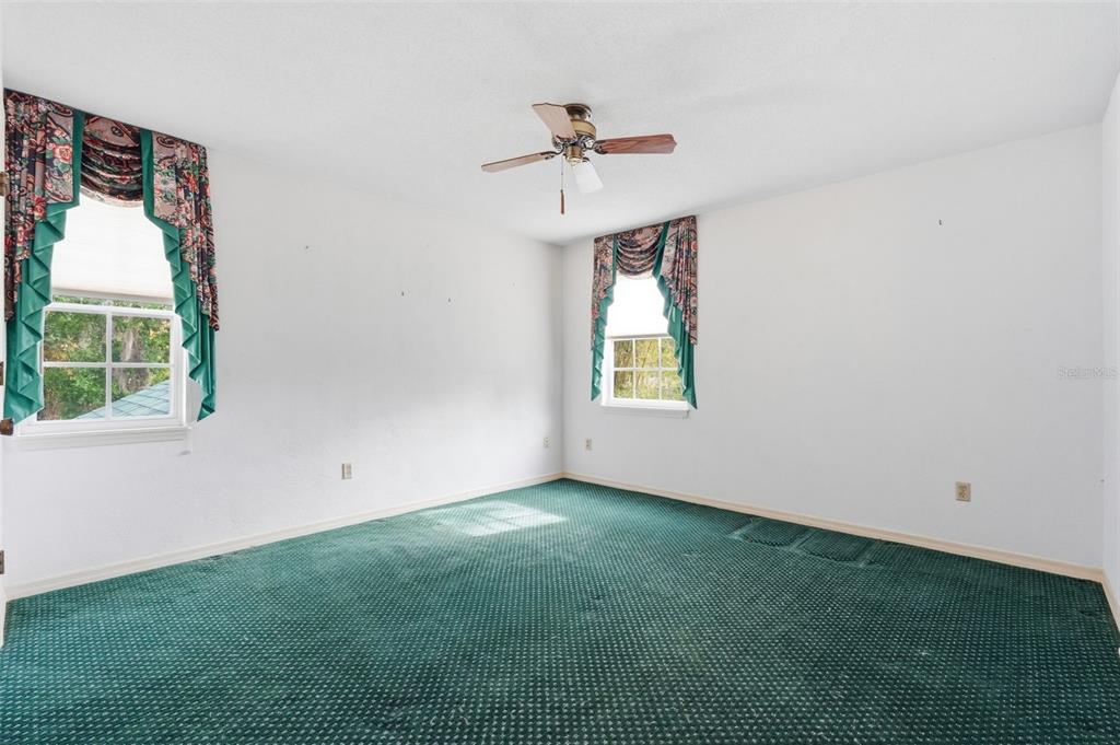 1840 Salem Court Dunedin, FL 34698 - Photo 31 of 64 an empty room with a window and a ceiling fan