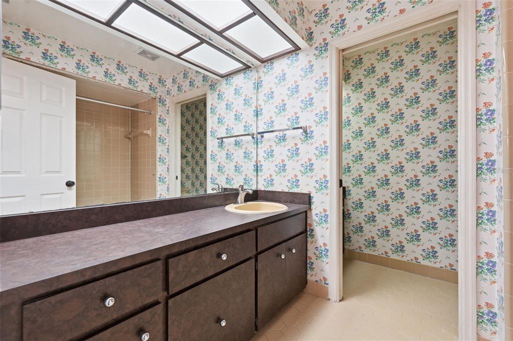 1840 Salem Court Dunedin, FL 34698 - Photo 33 of 64 a bathroom with a sink a vanity and a mirror