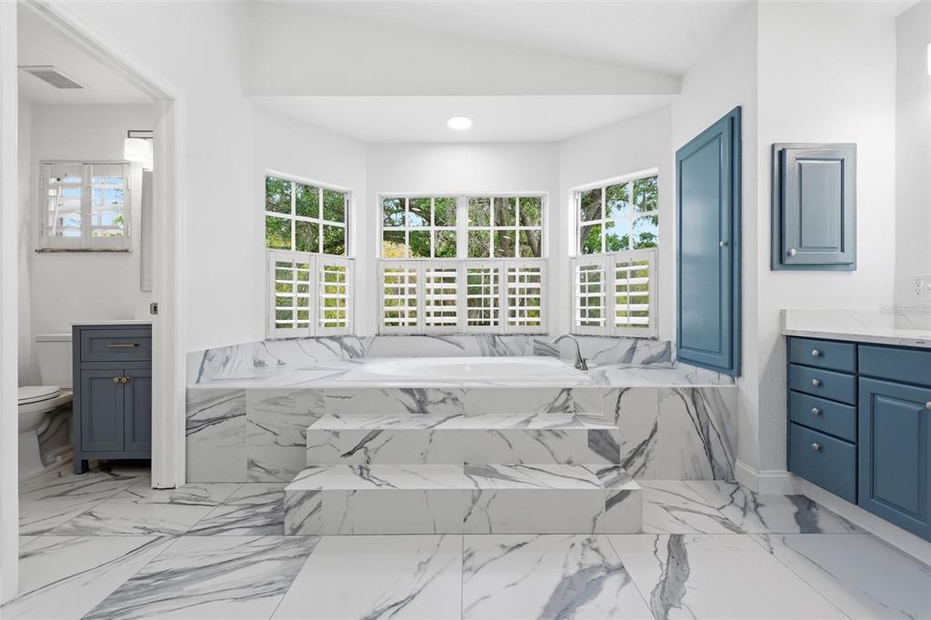 1840 Salem Court Dunedin, FL 34698 - Photo 49 of 64 a spacious bedroom with a large bed and a window