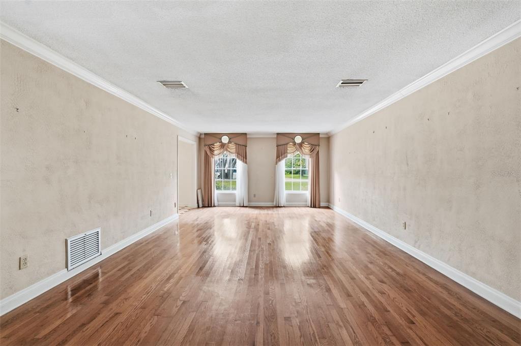 1840 Salem Court Dunedin, FL 34698 - Photo 5 of 64 wooden floor in an empty room with a window