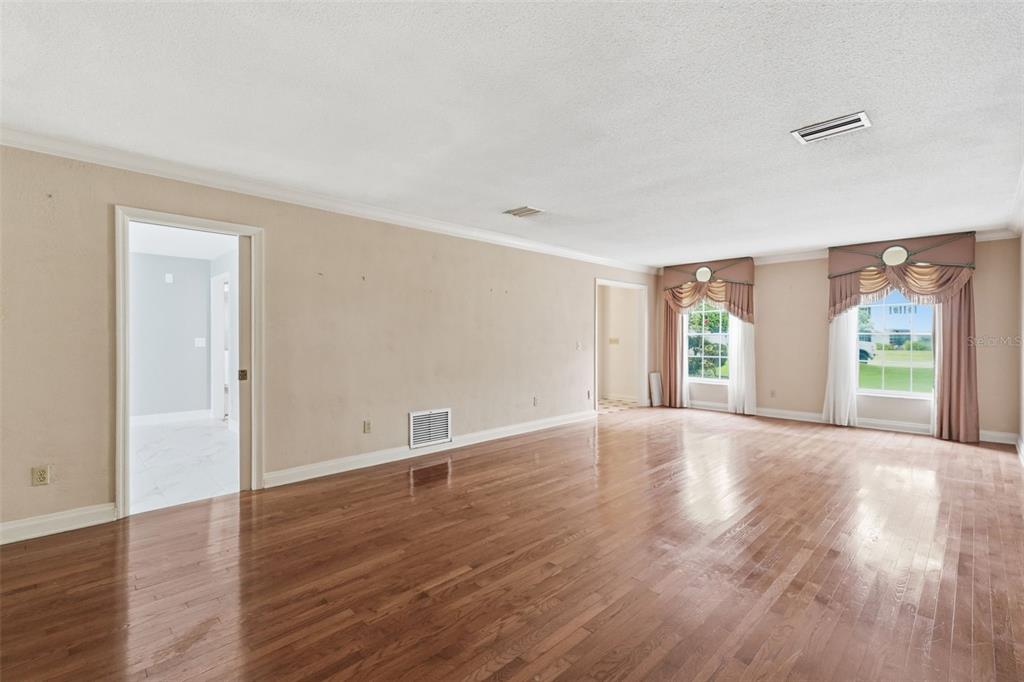 1840 Salem Court Dunedin, FL 34698 - Photo 6 of 64 a view of an empty room with wooden floor and a window