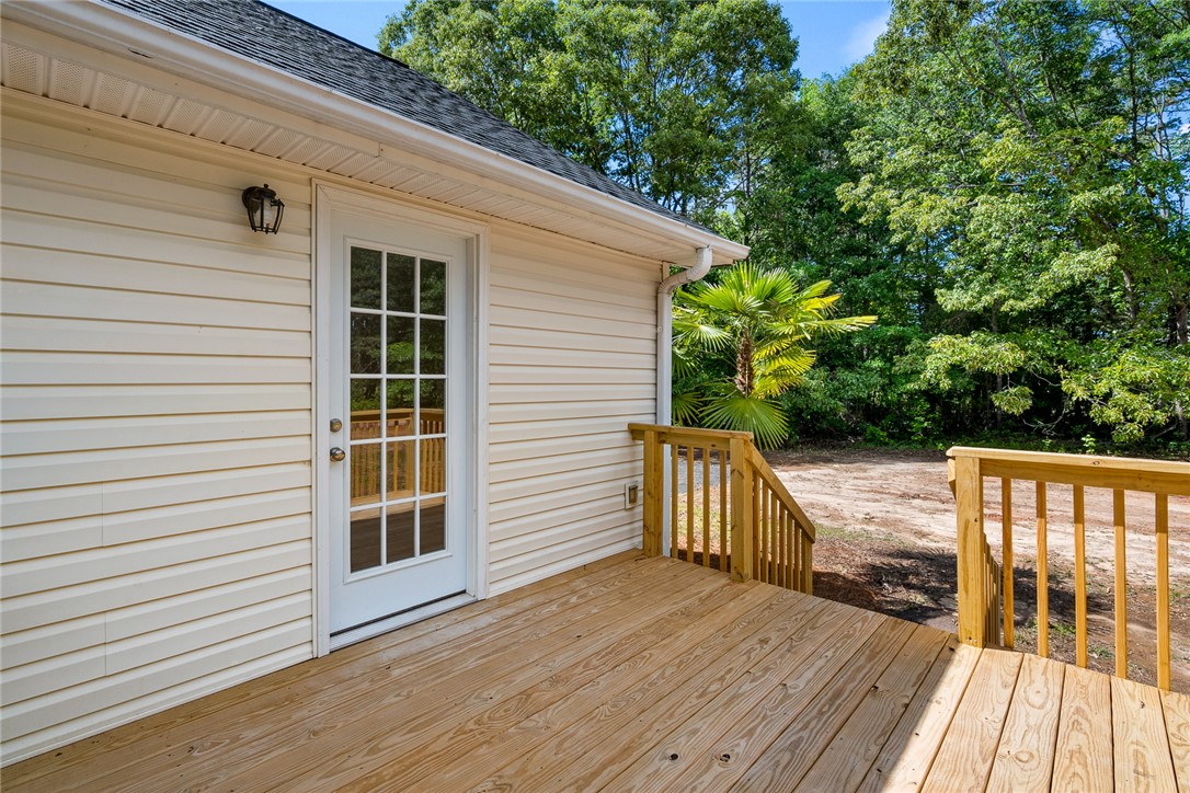 131 Lockaby Road Pelzer, SC 29669 - Photo 35 of 50 This charming home offers a new wooden deck and lush backyard, perfect for outdoor living.