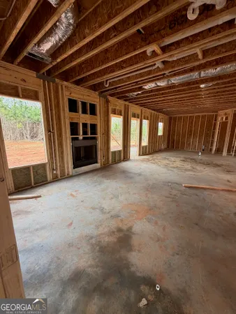 a view of an empty room with a fireplace and a window