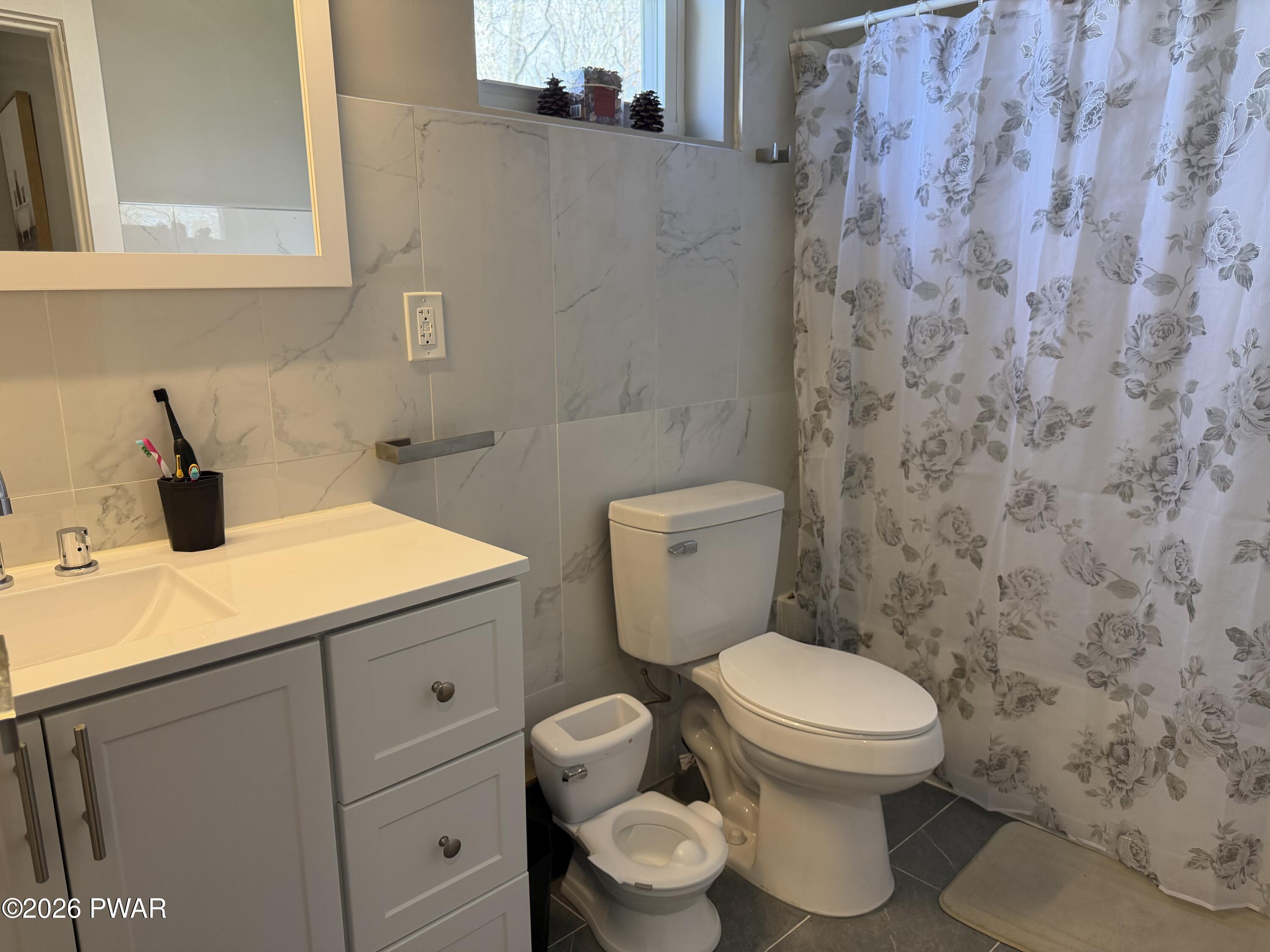 801 Maple Ridge Court Hawley, PA 18428 - Photo 41 of 55 a bathroom with a toilet sink and mirror