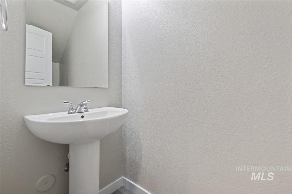 2500 East Blue Tick Street Meridian, ID 83642 - Photo 17 of 24 Bathroom featuring a textured wall and lofted ceiling