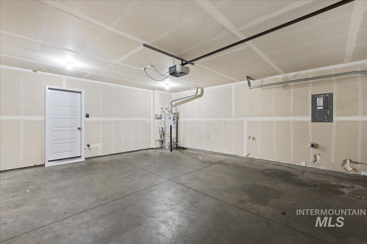 2500 East Blue Tick Street Meridian, ID 83642 - Photo 20 of 24 Garage featuring electric panel, water heater, and a garage door opener