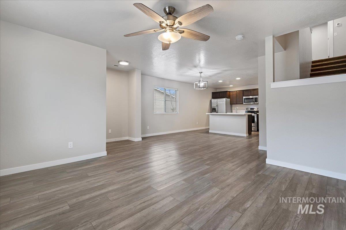 2500 East Blue Tick Street Meridian, ID 83642 - Photo 5 of 24 Unfurnished living room with recessed lighting, ceiling fan, and dark wood-type flooring