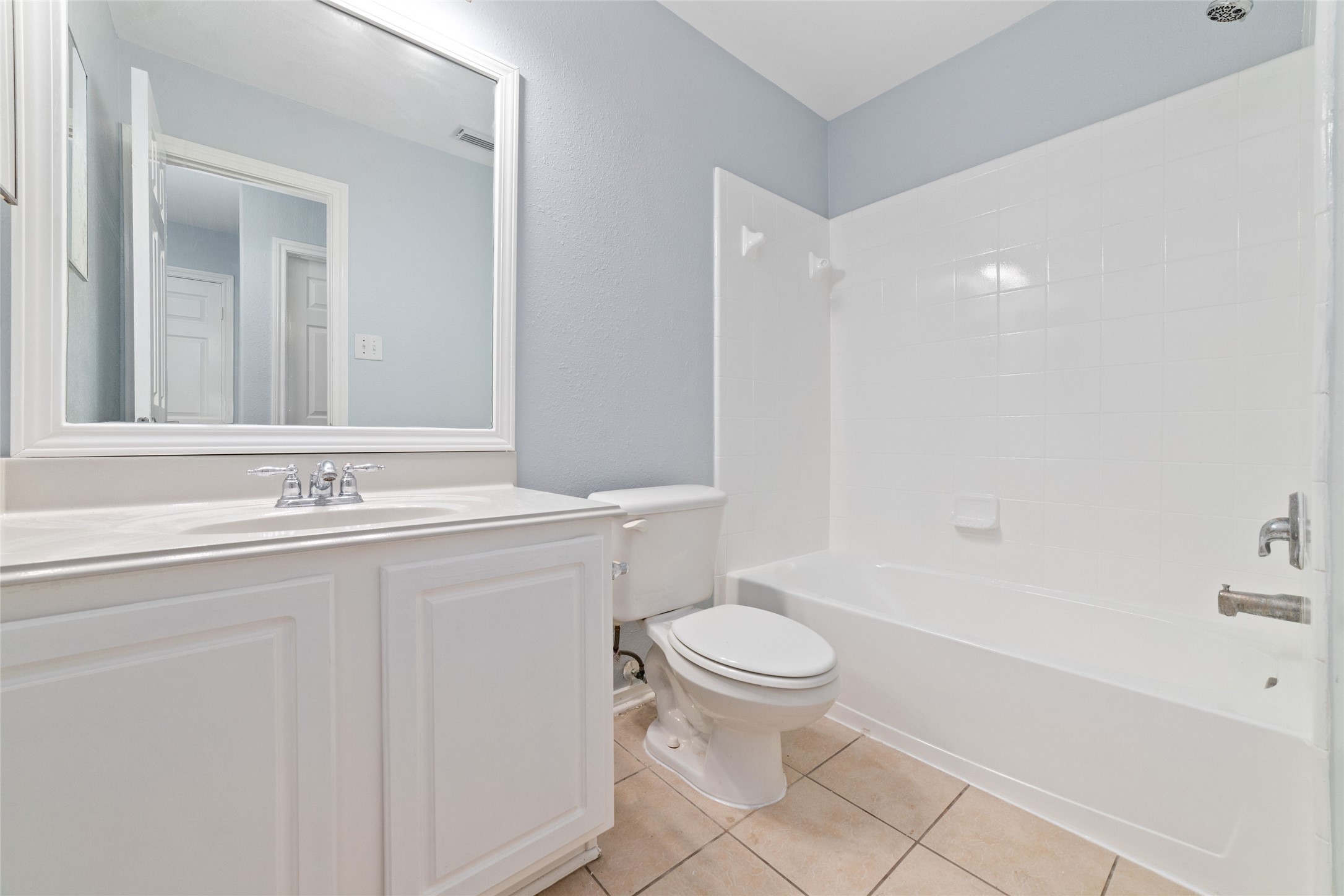 8734 Rainglen Lane Houston, TX 77044 - Photo 20 of 28 a bathroom with a sink toilet and shower