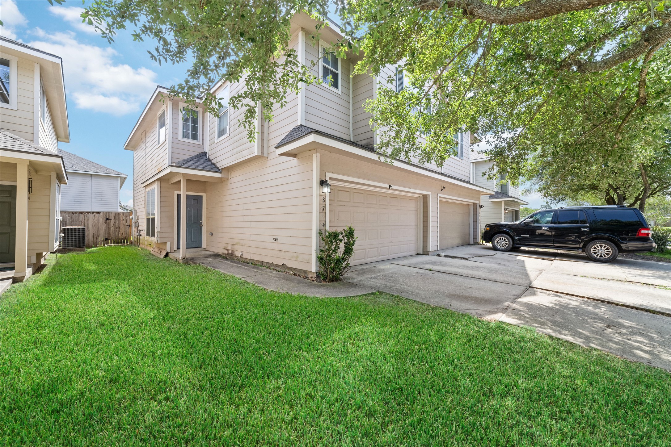 8734 Rainglen Lane Houston, TX 77044 - Photo 2 of 28 a view of a white house in front of a yard with large tree