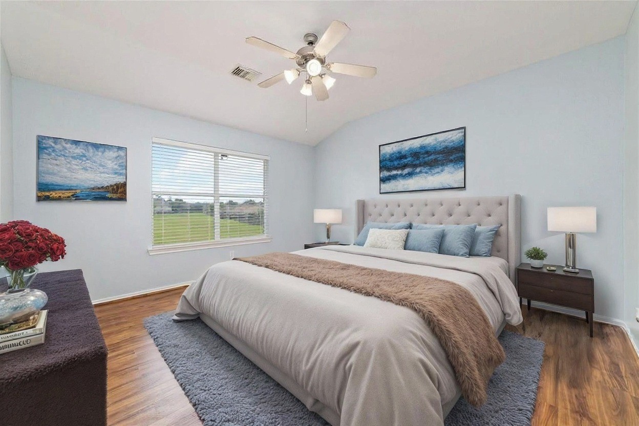 8734 Rainglen Lane Houston, TX 77044 - Photo 24 of 28 a spacious bedroom with a bed and a chandelier