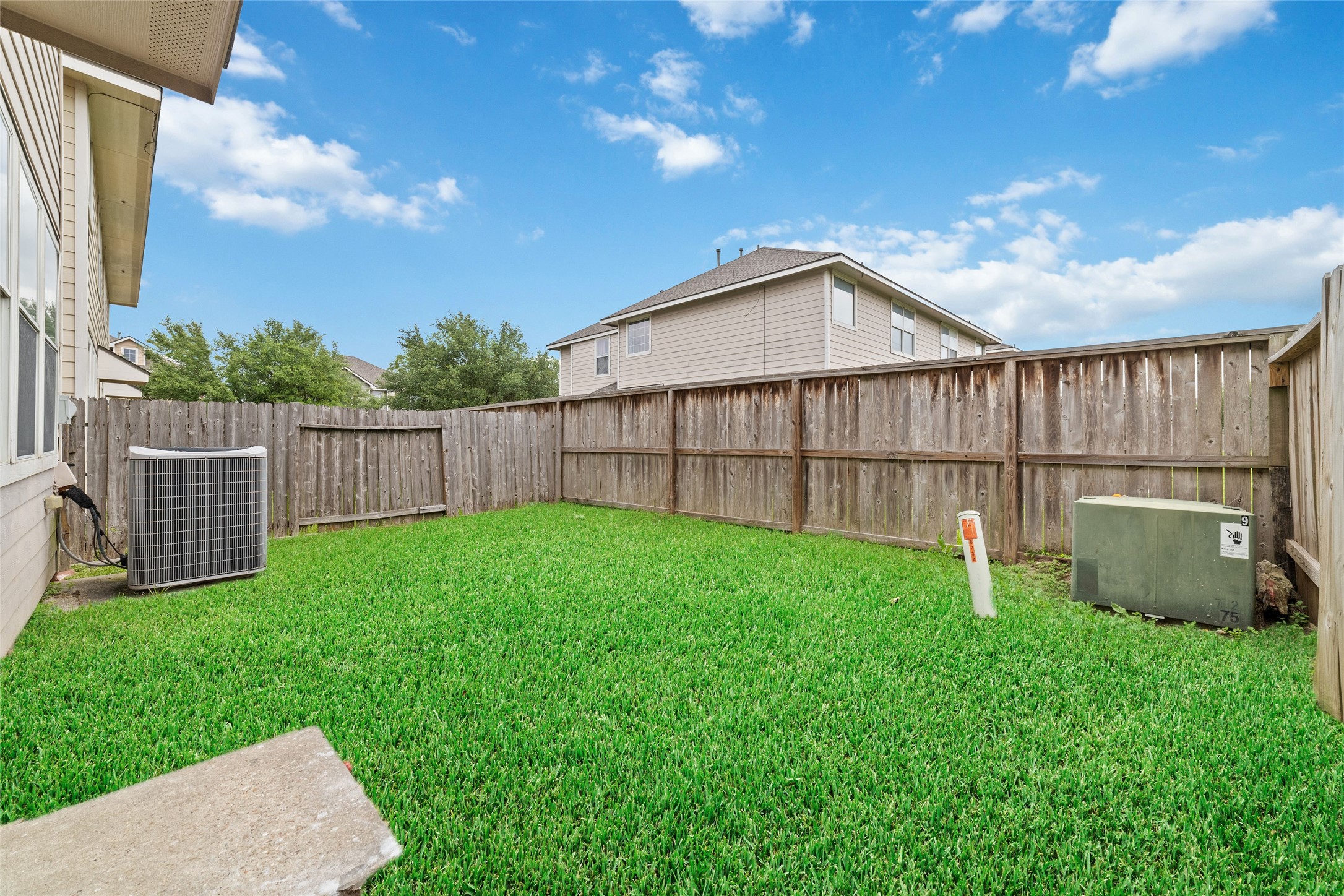 8734 Rainglen Lane Houston, TX 77044 - Photo 28 of 28 a backyard of a house with lots of green space