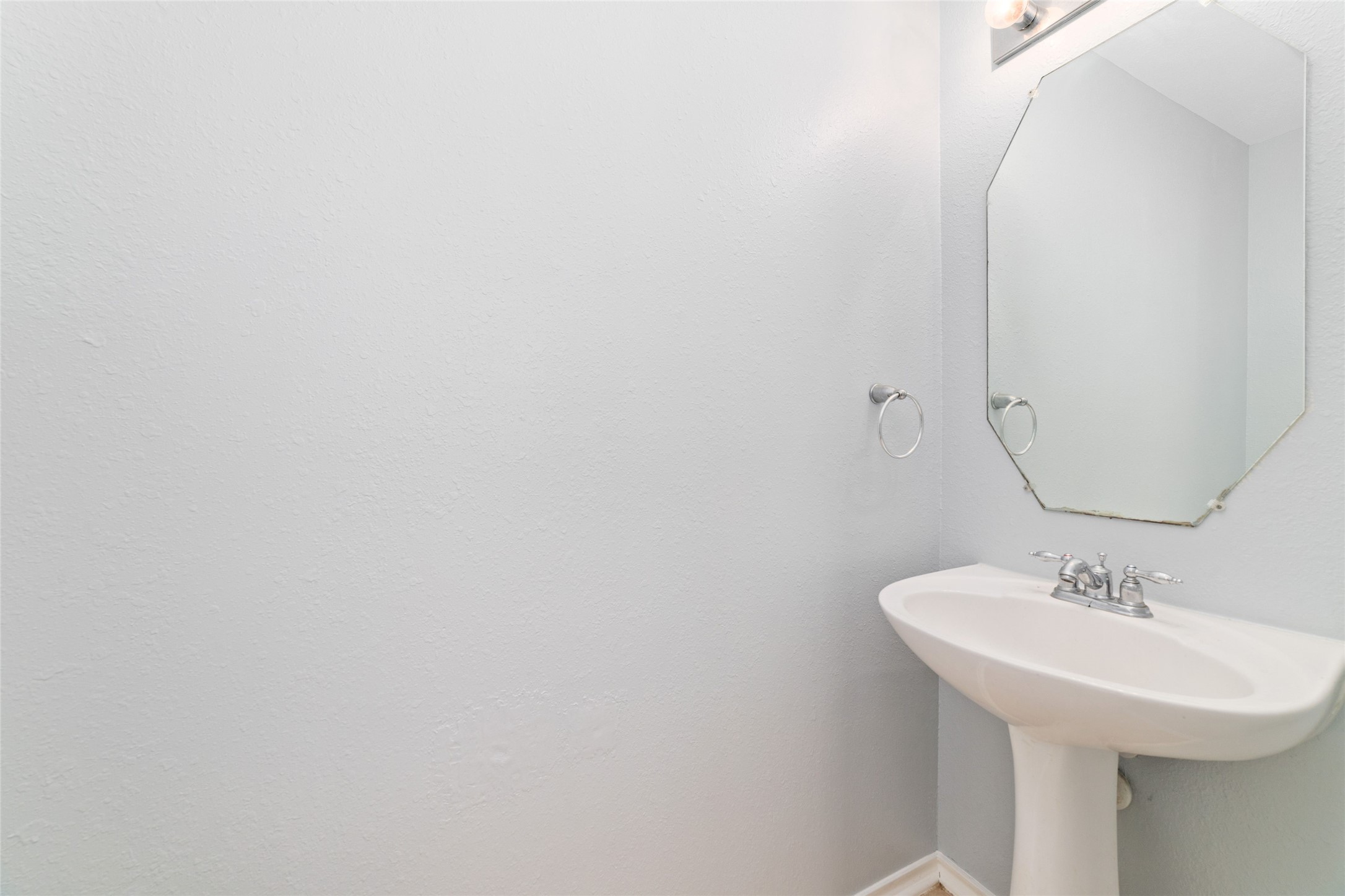 8734 Rainglen Lane Houston, TX 77044 - Photo 6 of 28 a bathroom with a sink and a mirror