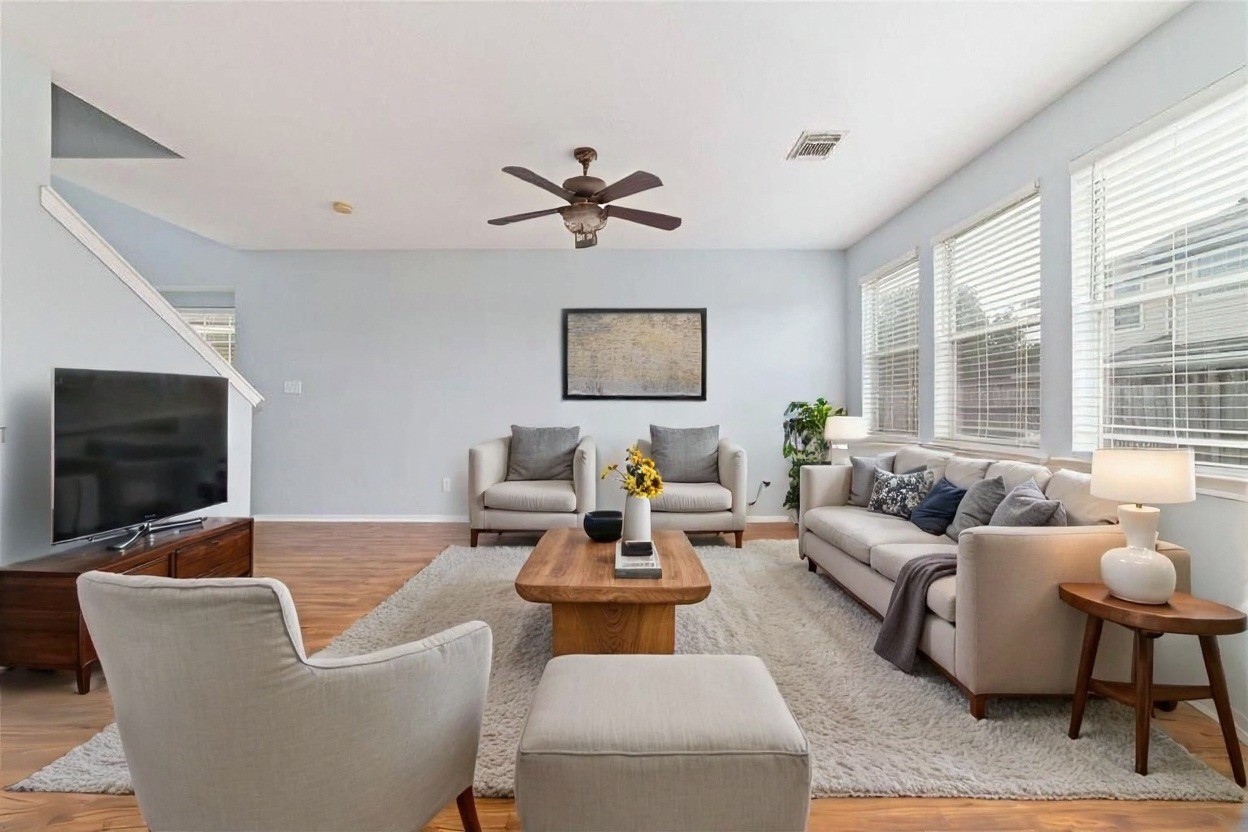 8734 Rainglen Lane Houston, TX 77044 - Photo 10 of 28 a living room with furniture and a flat screen tv