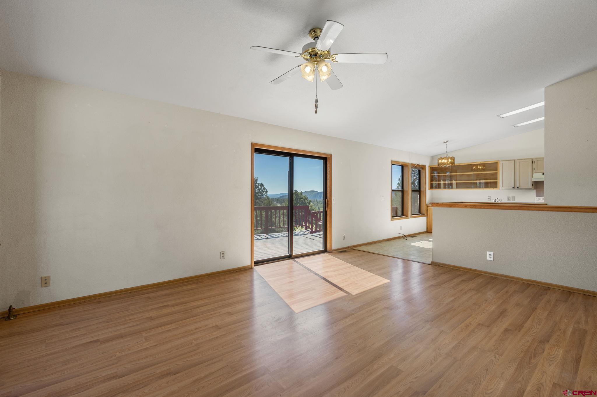 720 Sawmill Road Durango, CO 81303 - Photo 4 of 41 a view of an empty room with a window and wooden floor