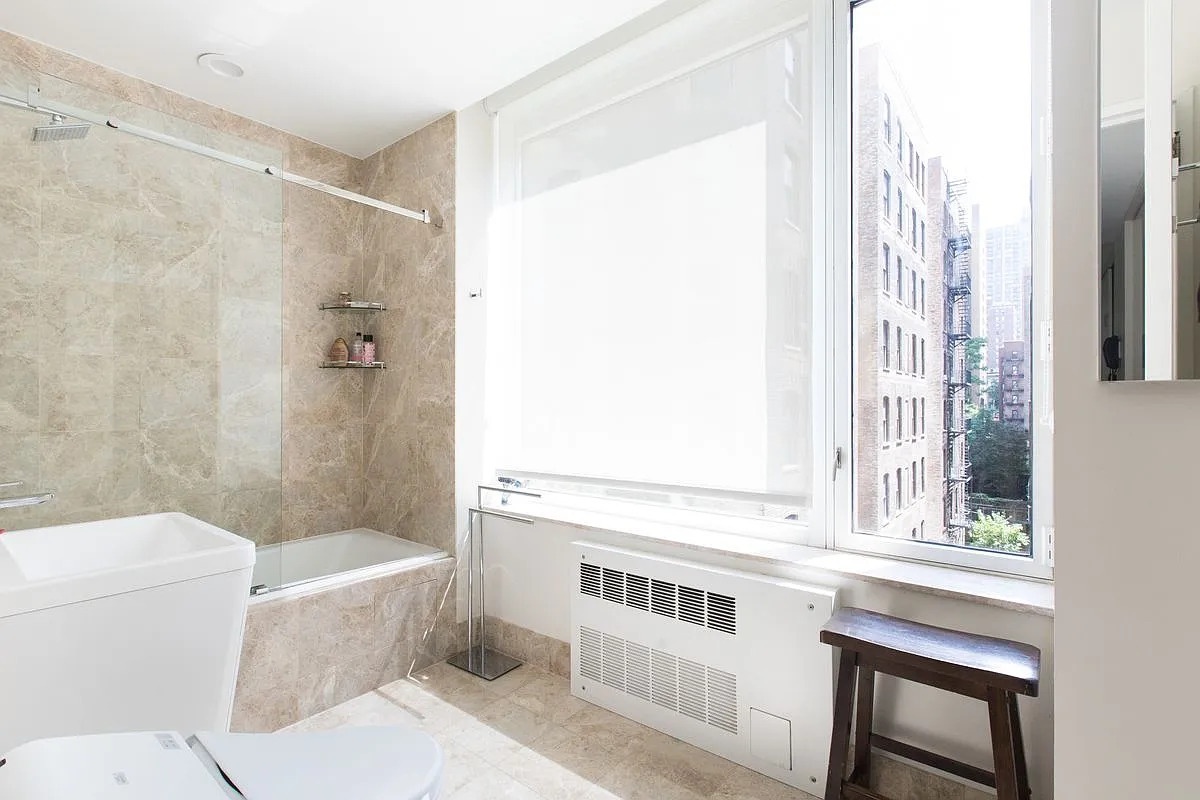 220 Riverside Boulevard, Unit 4D Manhattan, NY 10069 - Photo 6 of 14 a bathroom with a sink a toilet and a shower