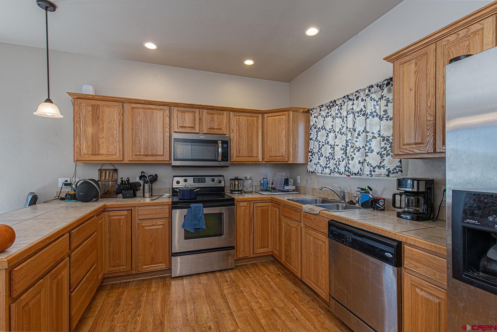 325 Star Crossing, Unit 2 Bayfield, CO 81122 - Photo 8 of 24 a kitchen with stainless steel appliances granite countertop a sink stove microwave and cabinets