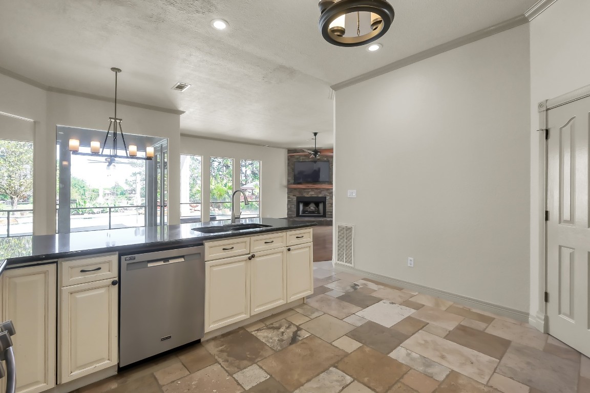 12758 Aries Loop Willis, TX 77318 - Photo 11 of 48 a kitchen with granite countertop a sink cabinets and window