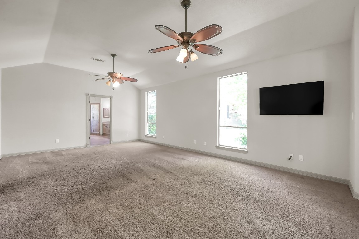 12758 Aries Loop Willis, TX 77318 - Photo 15 of 48 a view of a livingroom with a flat screen tv ceiling fan and window