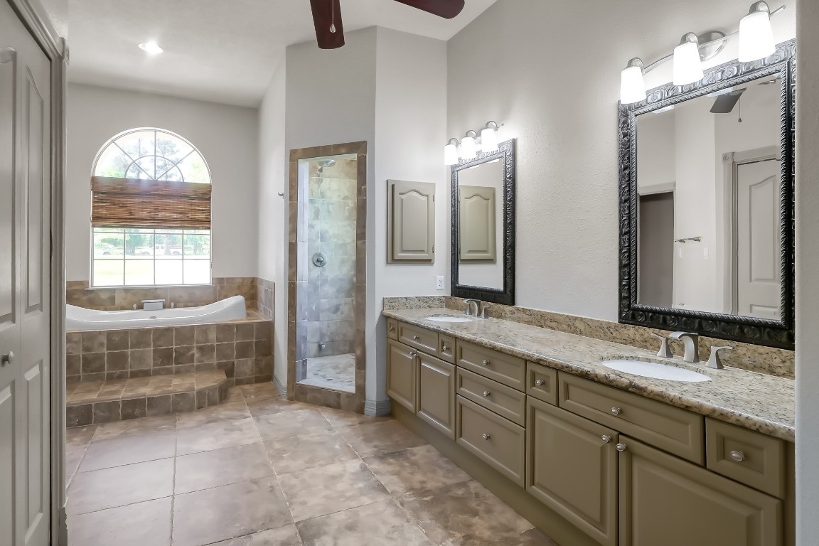 12758 Aries Loop Willis, TX 77318 - Photo 17 of 48 a bathroom with a double vanity sink and a mirror