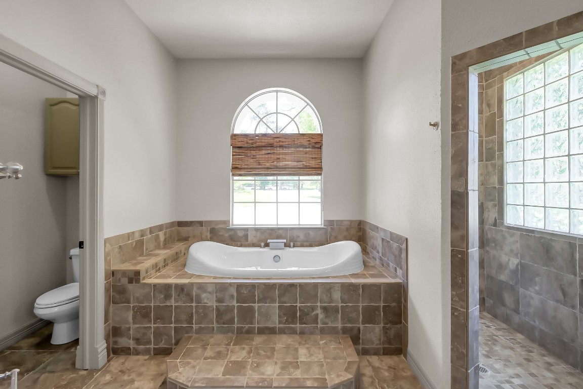 12758 Aries Loop Willis, TX 77318 - Photo 18 of 48 a bathroom with a sink toilet and window