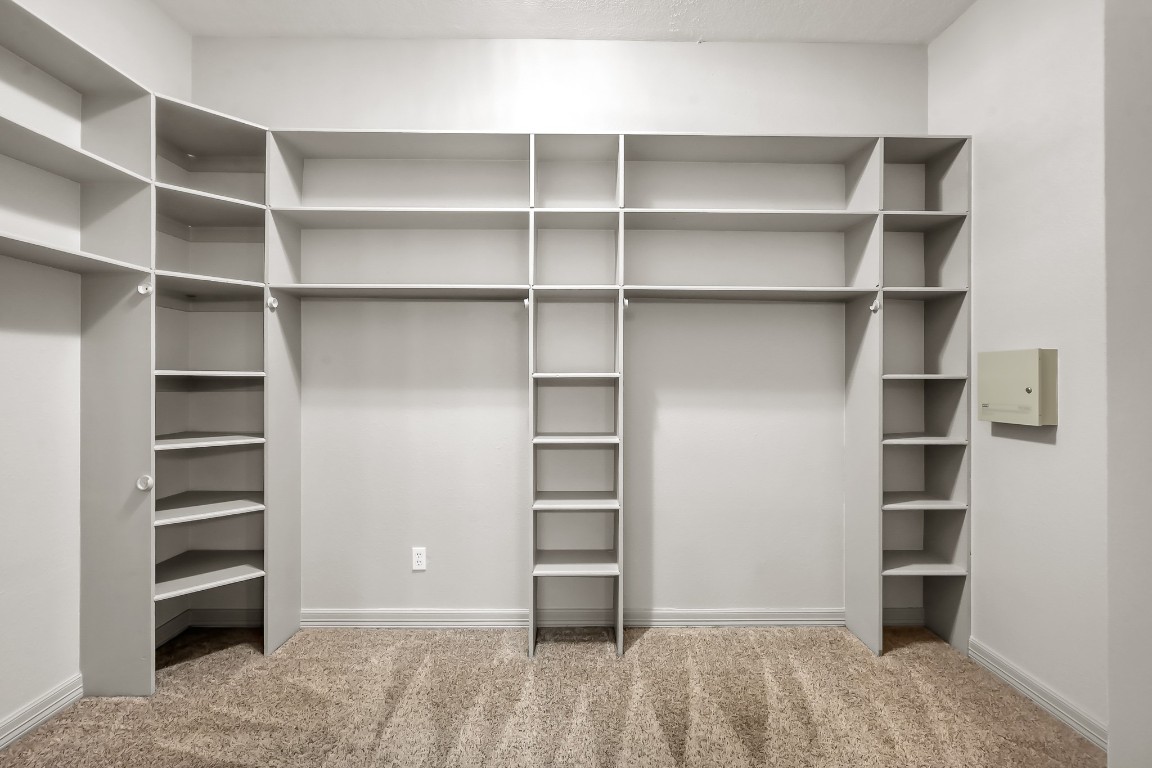 12758 Aries Loop Willis, TX 77318 - Photo 19 of 48 a view of walk in closet with empty racks