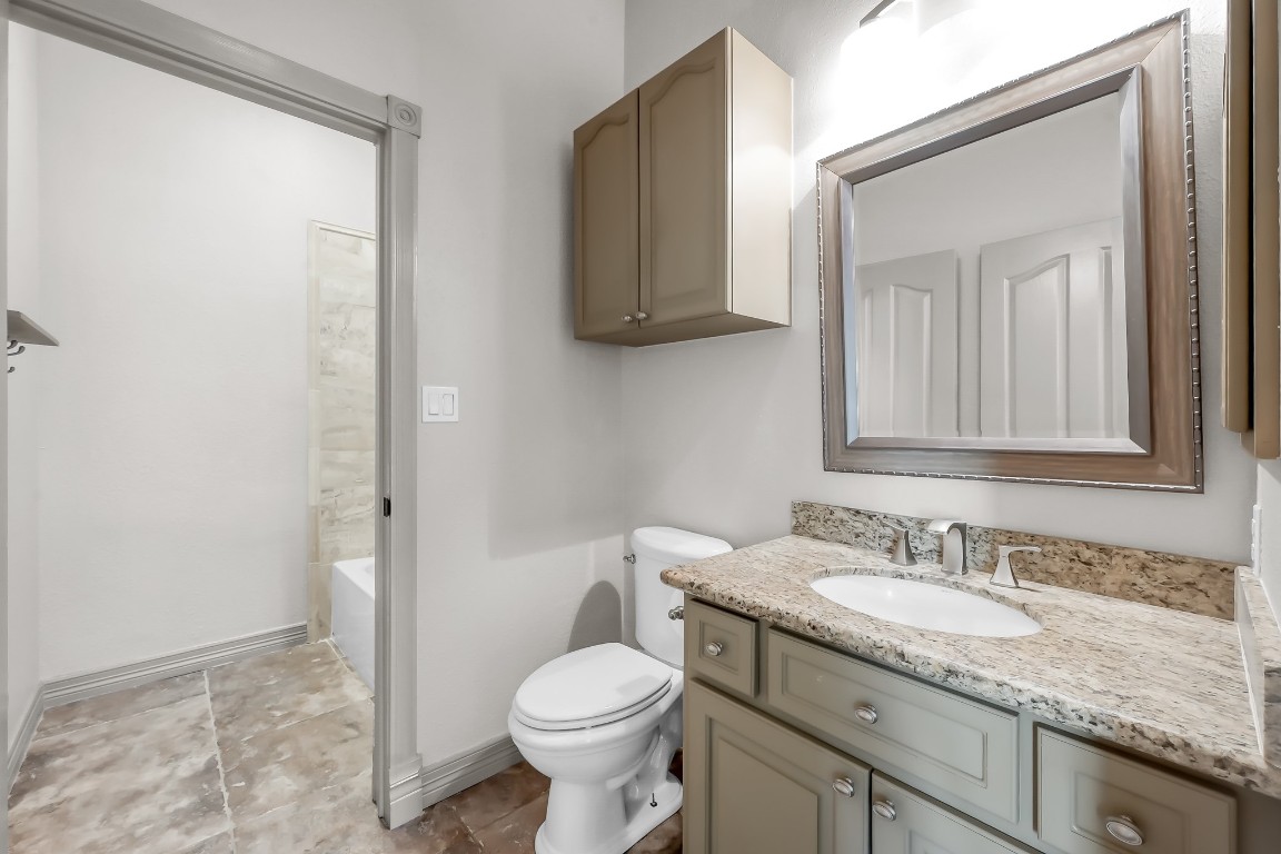 12758 Aries Loop Willis, TX 77318 - Photo 25 of 48 a bathroom with a granite countertop sink toilet and shower